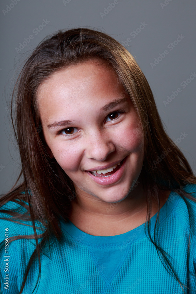 12 year old girl in studio with a blue top and many expressions Stock
