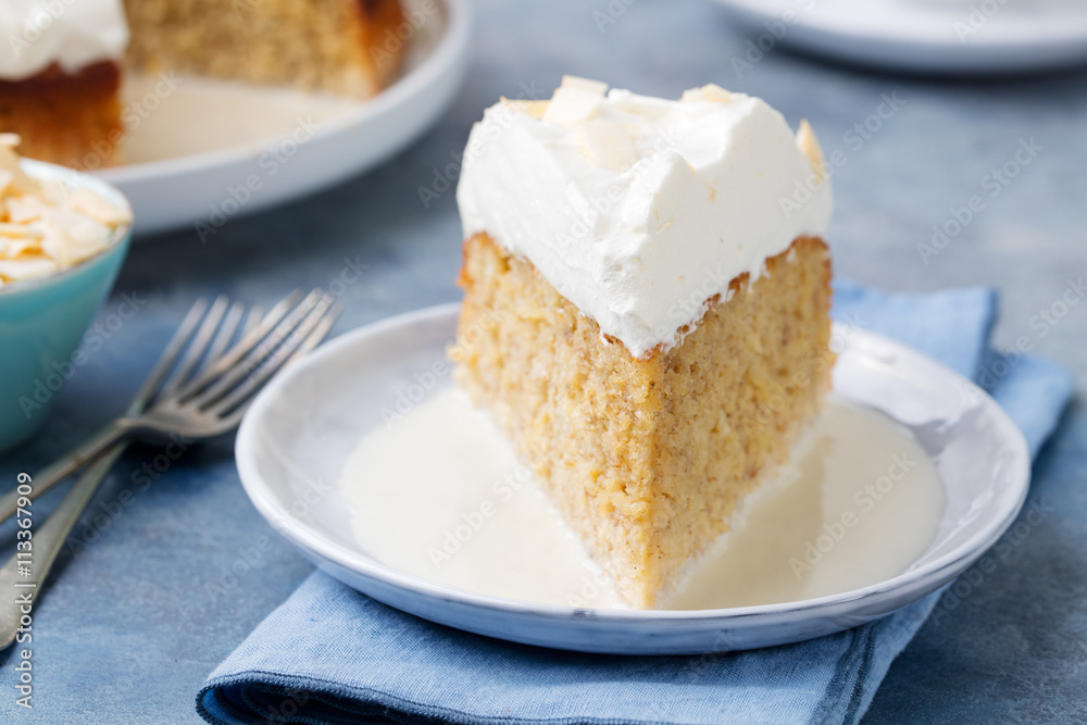 Three milk cake, tres leches cake with coconut. Traditional dessert of Latin America Three milk cake, tres leches cake with coconut. Traditional dessert of Latin America