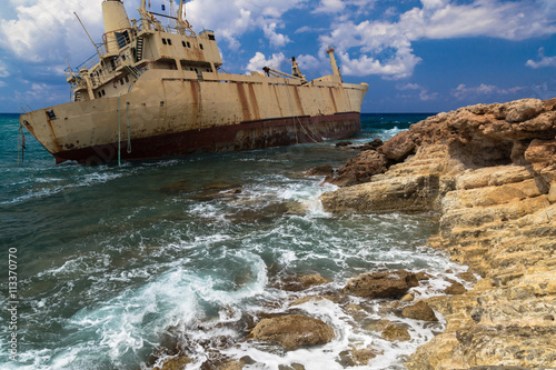 Seascape: boat shipwrecked near the rocky shore. Mediterranean, near Paphos. Cyprus