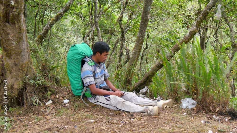hiker using smartphone to call for help he got lost in the woods hiker using smartphone to call for help he got lost in the woods