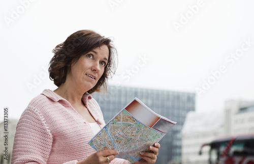 Confused woman holding map photo