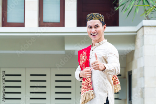 Asian Muslim man wearing traditional dress photo