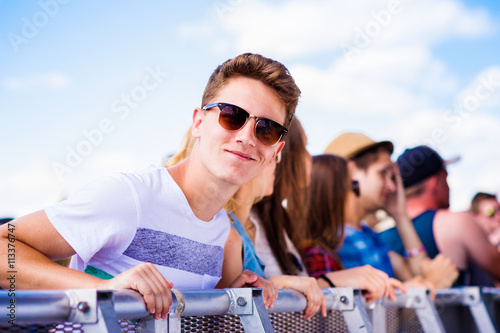 Teenagers at summer music festival, at the barrier © Halfpoint