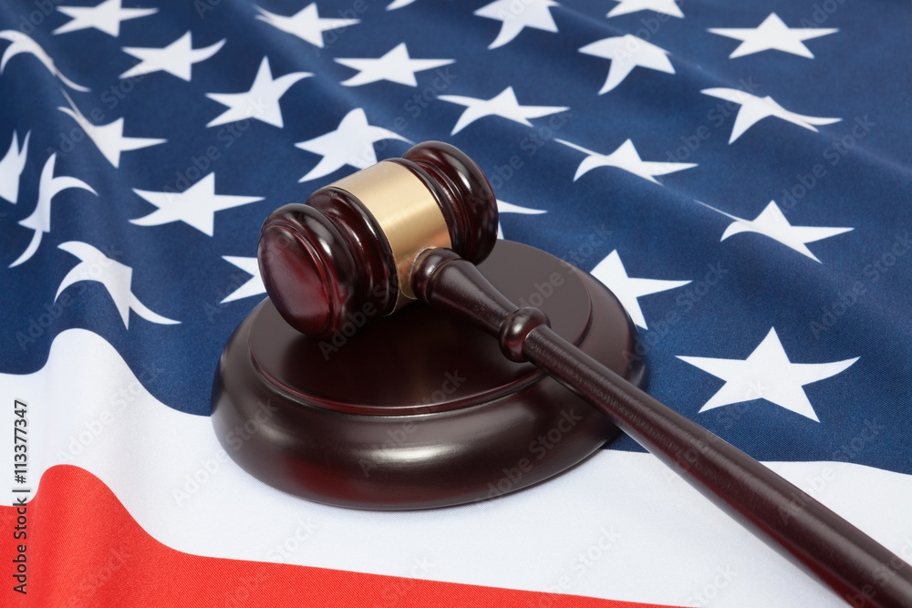 Close up shot of a judge gavel over United States flag
