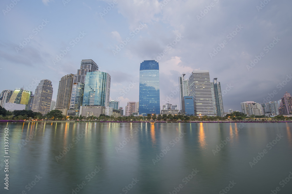 bangkok City view in public park with water reflection during twilight