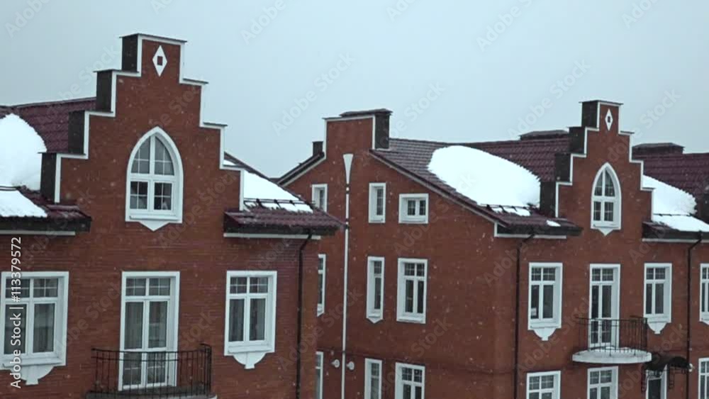 Snow against red brick townhouses super slow motion shot Snow against red brick townhouses super slow motion shot