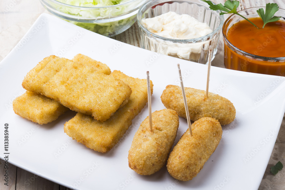 croquettes balls and different kind of sauces on a plate on a cl croquettes balls and different kind of sauces on a plate on a cl