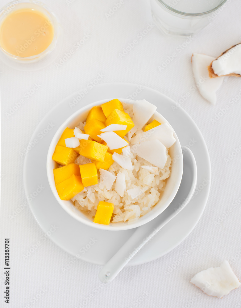 Rice pudding with mango and coconut water in a bowl, khao niaow ma muang White background Rice pudding with mango and coconut water in a bowl, khao niaow ma muang White background