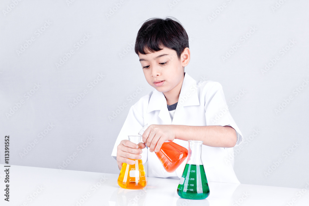 Asian boy doing science experiment with color liquid Asian boy doing science experiment with color liquid