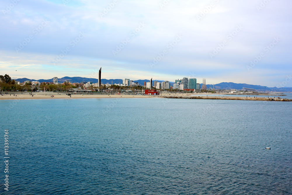 Barcelona landscape, view from Port Olimpic on Mediterranean sea, Playa de la Nova Icaria and skyscrapers.