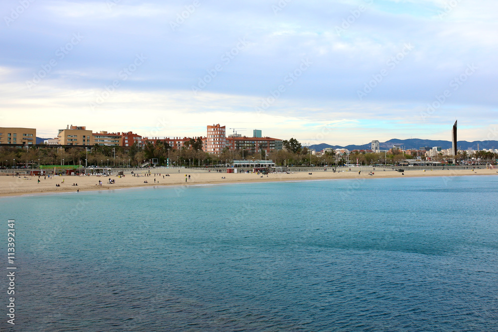 Barcelona landscape, view from Port Olimpic on Mediterranean sea, Playa de la Nova Icaria and skyscrapers.
