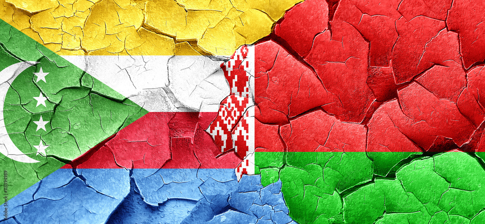 Comoros flag with Belarus flag on a grunge cracked wall Comoros flag with Belarus flag on a grunge cracked wall