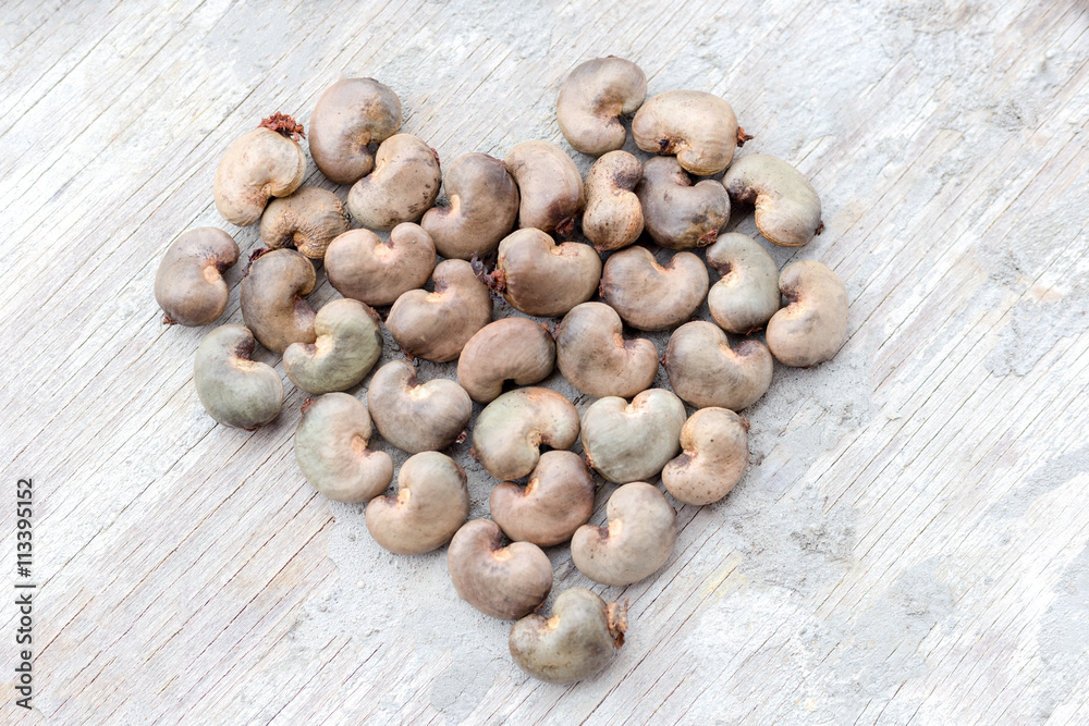 Heart shape collection of raw cashew nuts in shell Heart shape collection of raw cashew nuts in shell