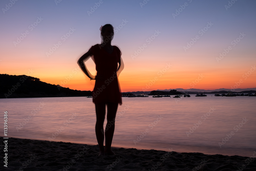 Silhouette of a woman on the sea in Sardinia