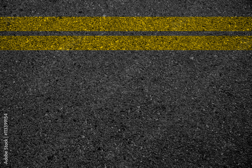 Double yellow line on asphalt road. © r_tee
