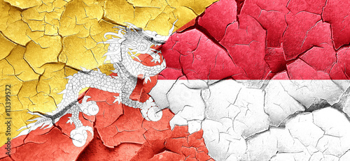 Bhutan flag with Indonesia flag on a grunge cracked wall