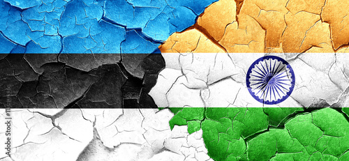 estonia flag with India flag on a grunge cracked wall