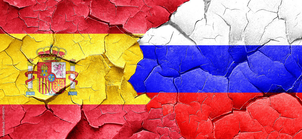 Spanish flag with Russia flag on a grunge cracked wall