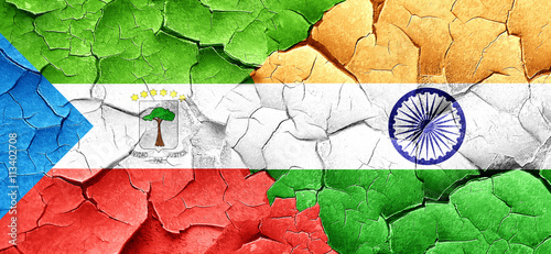 Equatorial guinea flag with India flag on a grunge cracked wall