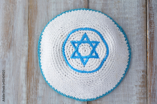 Flat lay of a Knitted kippah with embroidered blue and white Sta