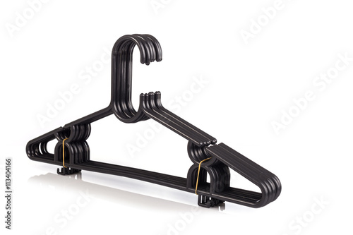 Close up pack of new black clothes hanger isolated on white .