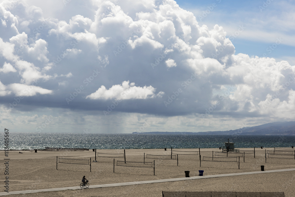 Picturesque thick clouds, beach landscape. Clouds over the beach in Santa Monica, United States. The ocean during strong winds.
