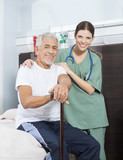 Nurse With Arm Around Patient In Rehab Center