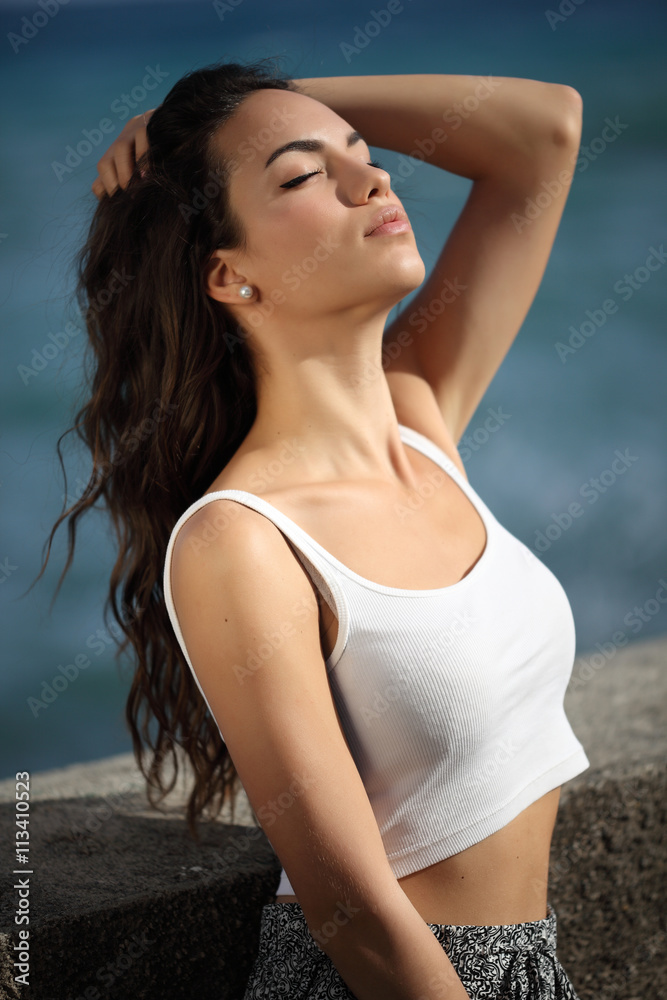Beautiful young woman outdoors portrait near the sea Beautiful young woman outdoors portrait near the sea
