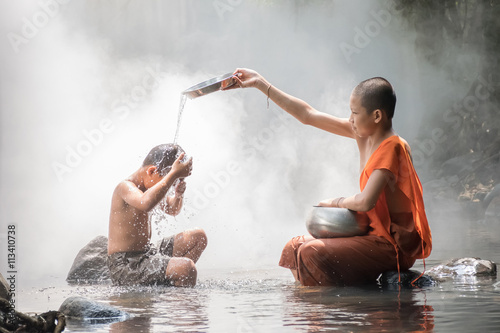 Monk and boy playing water