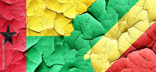 Guinea bissau flag with congo flag on a grunge cracked wall