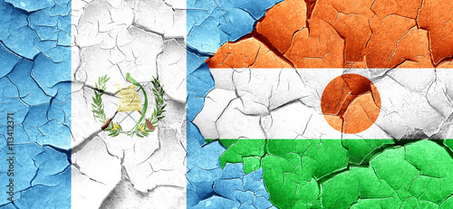 guatemala flag with Niger flag on a grunge cracked wall