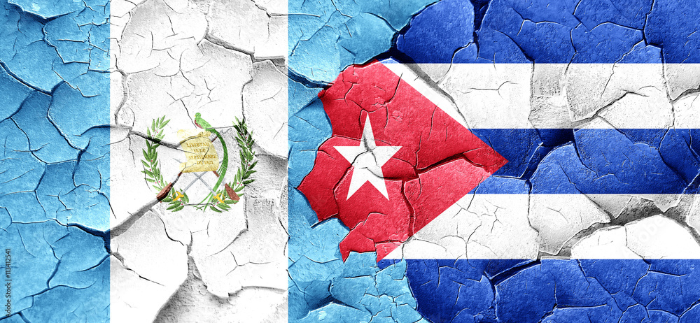 guatemala flag with cuba flag on a grunge cracked wall