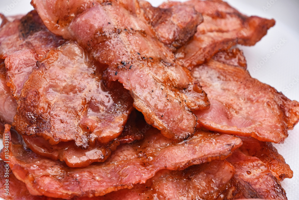 Crispy fried bacon slices cooked on bbq grill Crispy fried bacon slices cooked on bbq grill