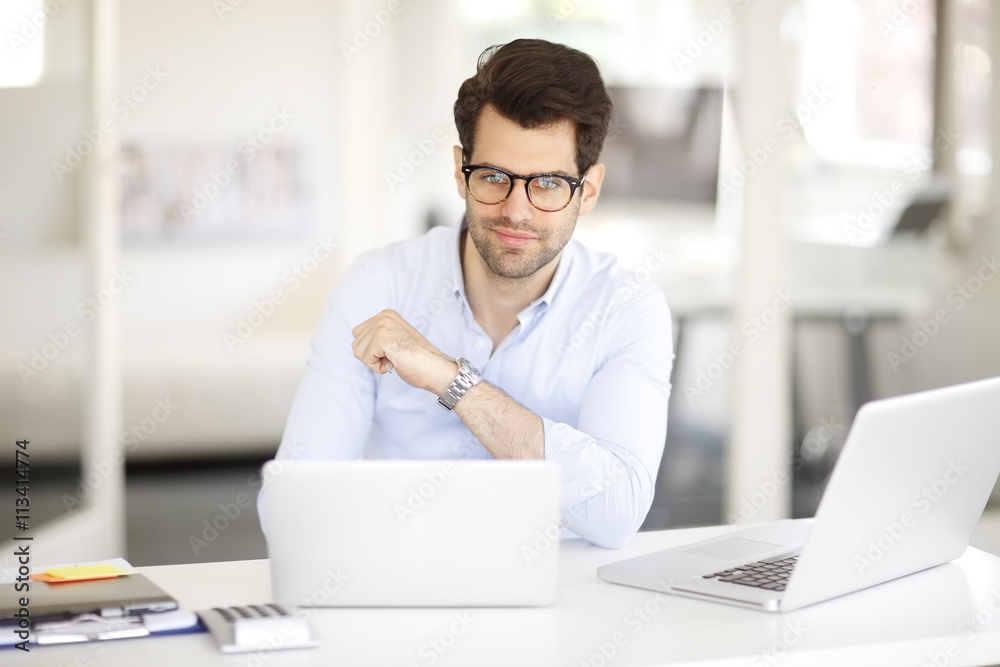 Solve the problem. Young businessman working on solving the problem on laptop at office. Solve the problem. Young businessman working on solving the problem on laptop at office.