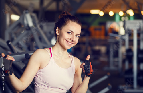 Young smiling happy woman in a fitness center