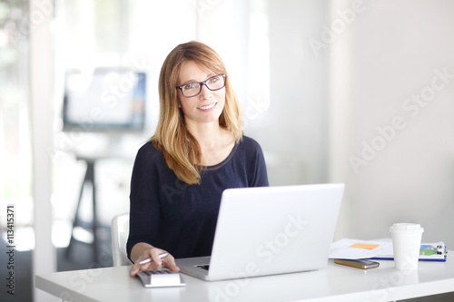 Executive businesswoman working on laptop at office 