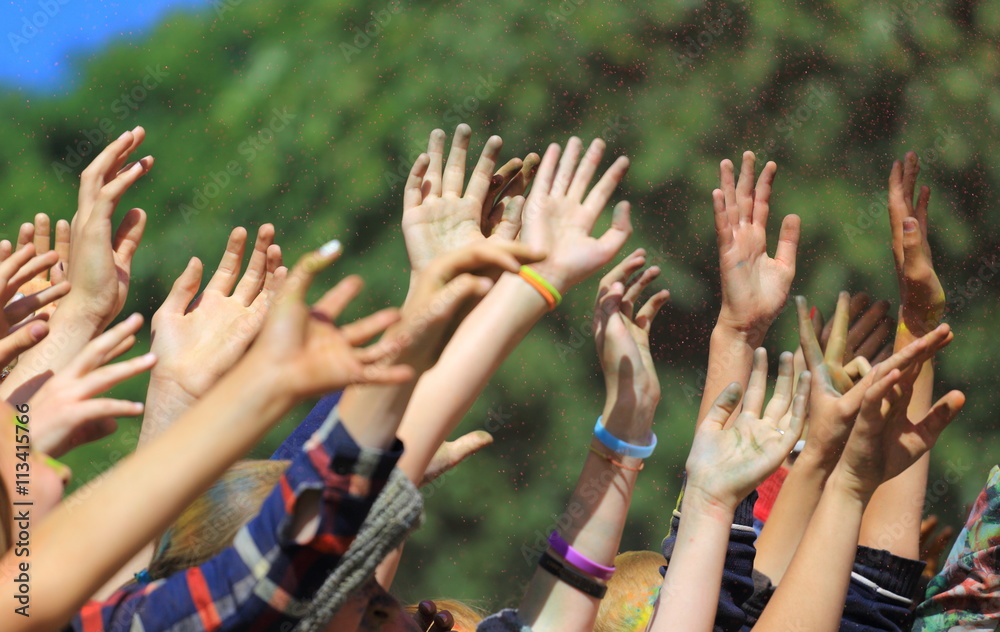 People with hands raised at a music festival