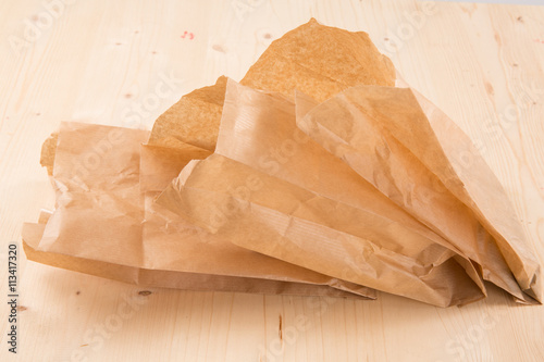 Packaging recycled kraft paper pouch isolated on wooden background with clipping path