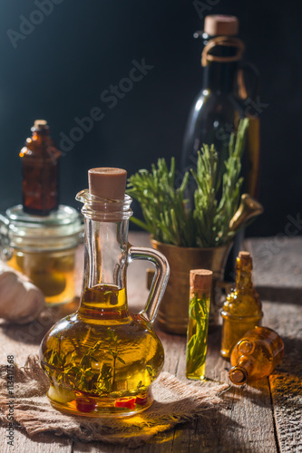 Glass bottle of olive oil with hrebs  photo