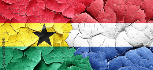 Ghana flag with Netherlands flag on a grunge cracked wall