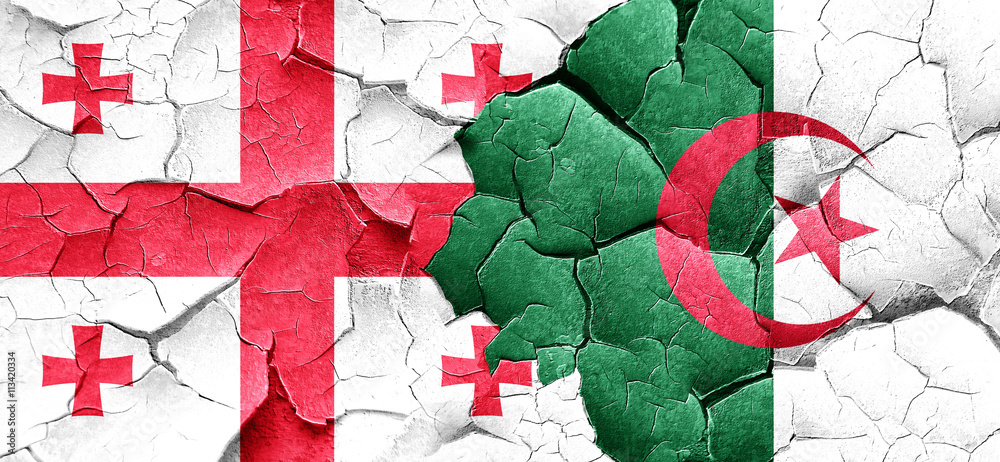 Georgia flag with Algeria flag on a grunge cracked wall Georgia flag with Algeria flag on a grunge cracked wall