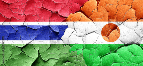 Gambia flag with Niger flag on a grunge cracked wall