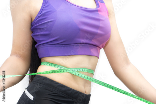 Woman in sport bra measuring her body with tape isolated on whit