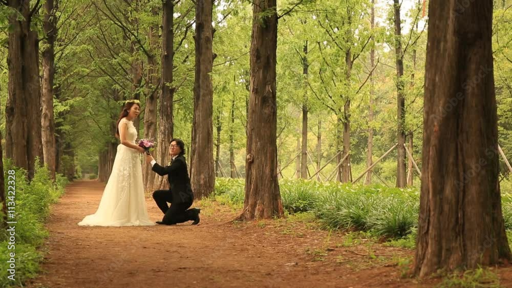 Groom kneeling and giving heart proposal Groom kneeling and giving heart proposal