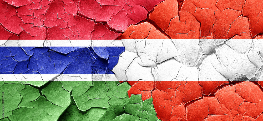 Gambia flag with Austria flag on a grunge cracked wall
