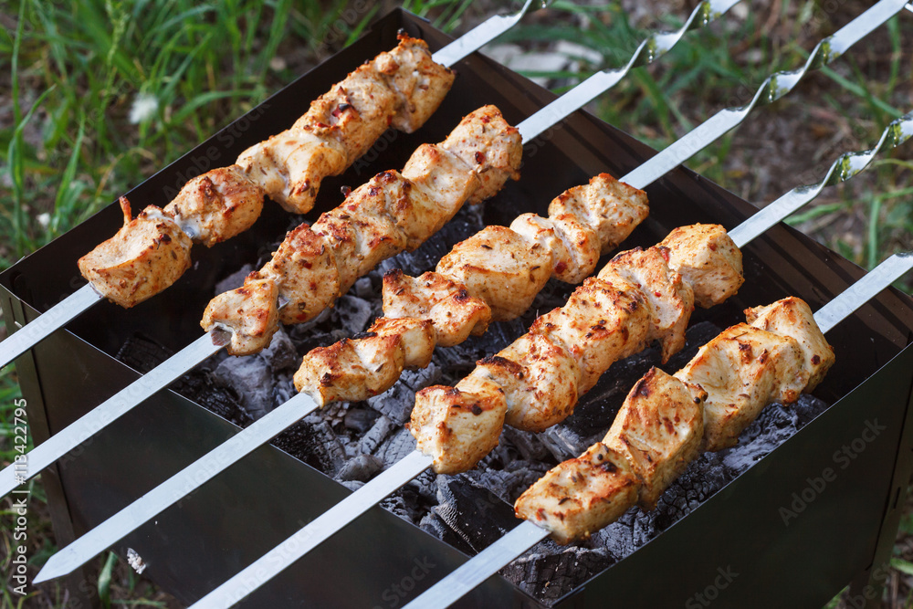Barbecue skewers with meat on the brazier. Chicken shish kebab