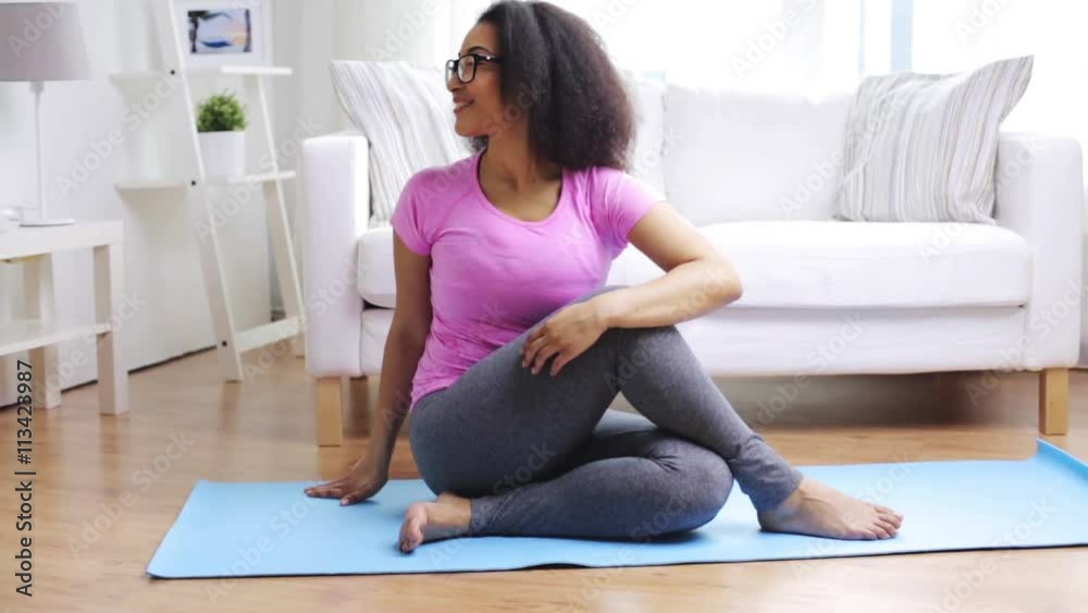 happy african woman exercising on mat at home happy african woman exercising on mat at home