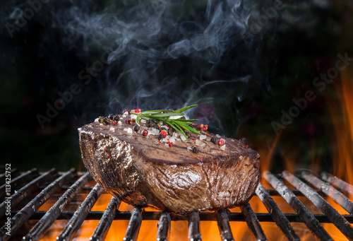 Grilled beef steak on the g...