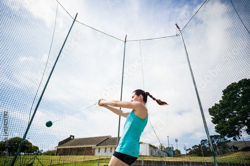 Athlete performing a hammer throw photo