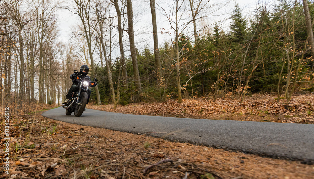 Obraz premium Man seat on the motorcycle on the road.